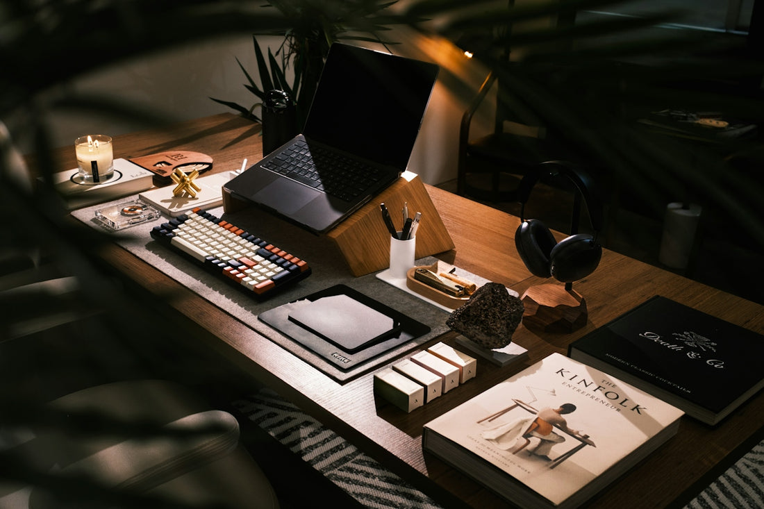 A modern desk setup with laptop and books